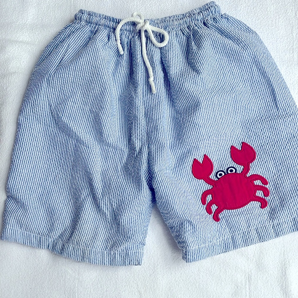 Smock Monkey swim trunks 5T, blue and white seersucker look with crab appliqué